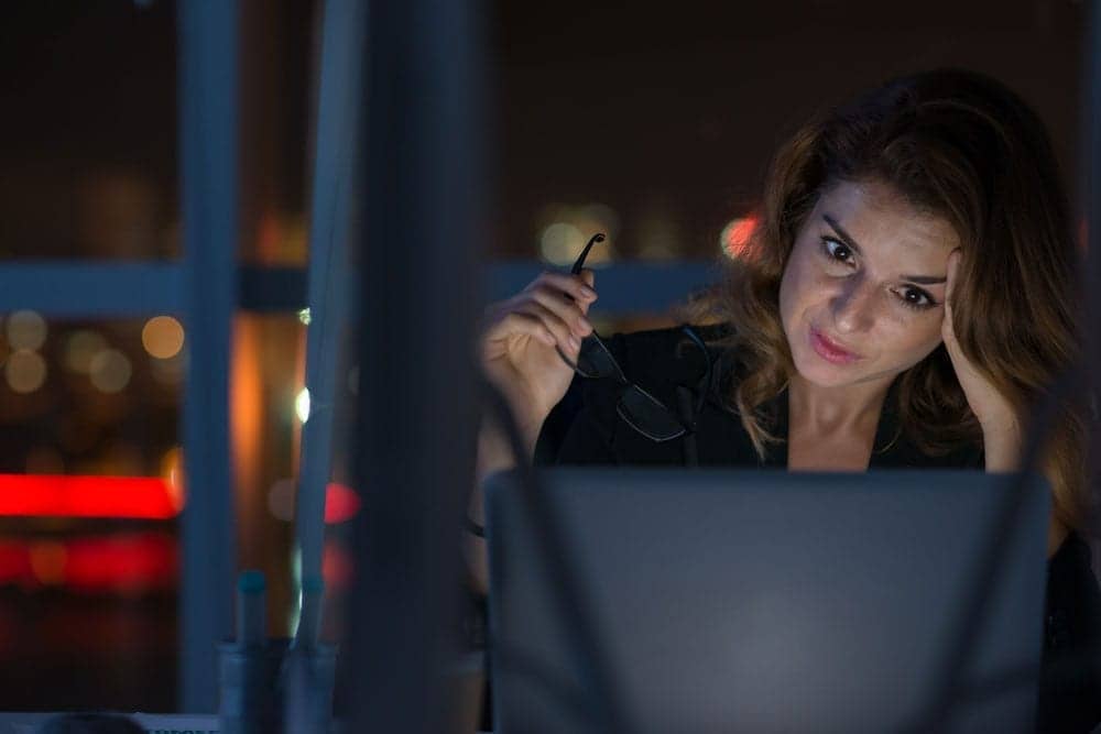 lady staring at laptop at night