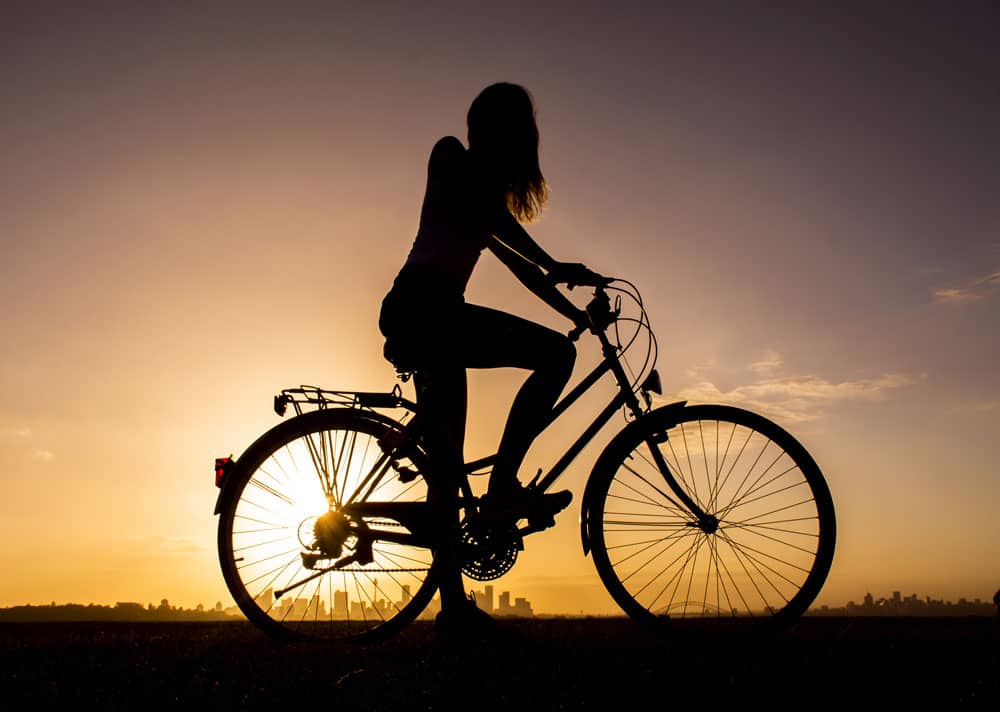 girl's silhouette on bike