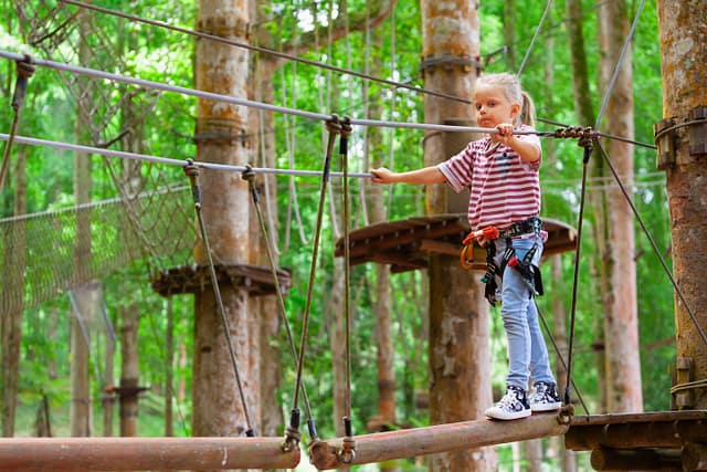 Young girl in harness at the Bali Treetop Adventure Park