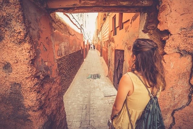 young girl wandering streets of marrakesh, morocco