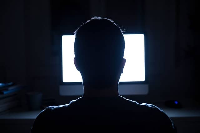 man using computer at night