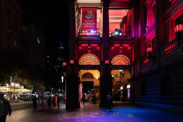 The Melbourne International Comedy Festival poster at night